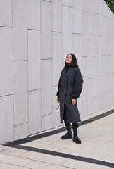 Portrait of a girl model in stylish clothes, shooting in an urban environment.