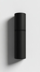 Minimalist black cylindrical container on a white background, showcasing sleek design and shadow