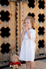 Little Boy In Folk Baptismal Shirt Playing Barefoot On Village Street, Wooden Bridge, Running Barefoot
