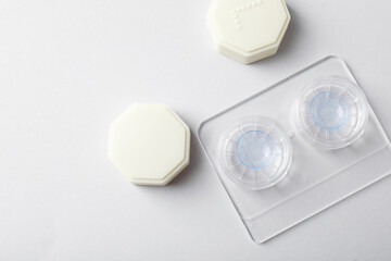 Case with contact lenses on white background, flat lay. Space for text