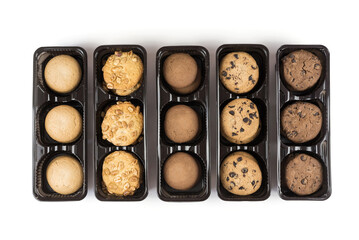 Various round cookies in an open box. Cookies in a pack on white
