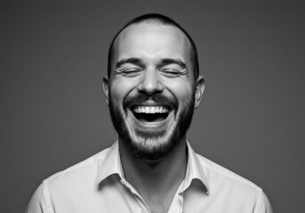 Obraz premium Man with beard and shirt laughing with eyes closed in monochrome isolated on white background