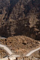 Oman, 03-06-2025: canyon and view of the winding road to Jebel Al Harim (Jabal Al Harim), the...