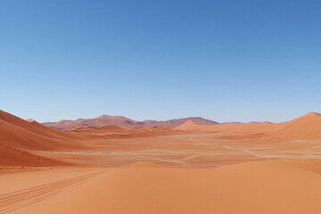 Fototapeta premium Vast desert landscape with golden sand dunes and clear blue sky under bright sunlight