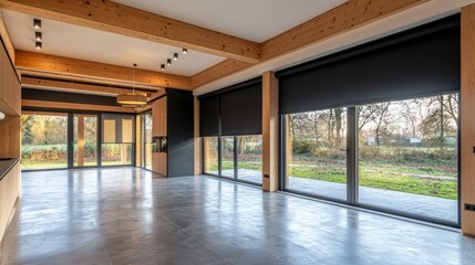 Obraz premium Modern, spacious open-plan living area with exposed beams, large windows, and contemporary design