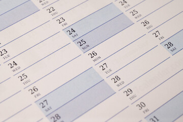 Close-up of calendar pages with numbered days and blue highlights
