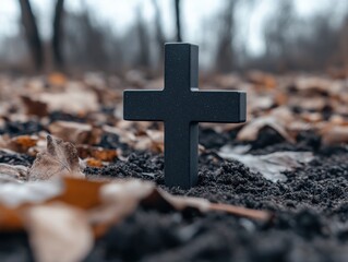 Dark cross in soil, autumn leaves