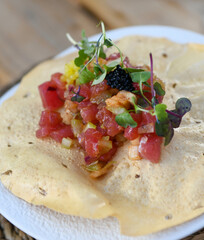 Fresh tuna ceviche starter on a crispy corn tortilla