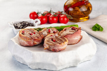 Tasty grilled pork medallion with bacon