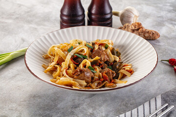 Asian cuisine udon with chicken and vegetables