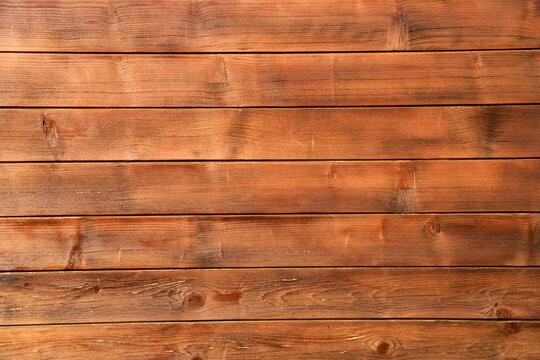 Redwood brown varnished plank backgroud backdrop. Wood floor background. lined Wooden flooring floor table surface outdoors material, natural color planks with varnish, top side front view.