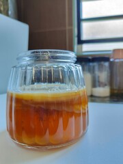 Kombucha tea in a glass jar.  SCOBY or Symbiotic Culture of Bacteria and Yeast. Symbiotic fermentation culture used in the production of kombucha.