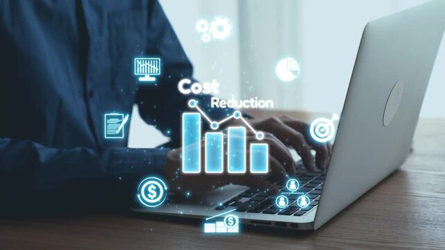 A focused professional collaborates with a laptop, surrounded by digital cost reduction graphics, emphasizing data analysis and financial planning strategies for business success. Qubit