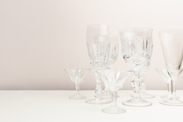 Crystal glasses in front of beige background. Place for your design.