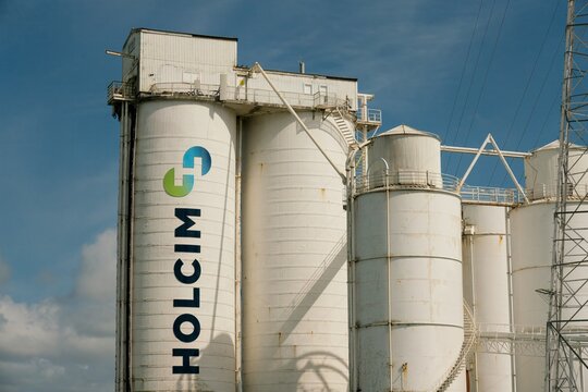 Large white industrial silo structure of Holcim New Zealand Ltd in Auckland, New Zealand