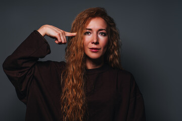 Young woman disappointed and tired emotional portrait on gray background