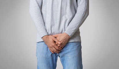 Man feeling pain in groin inflammation or bladder problem, cropped