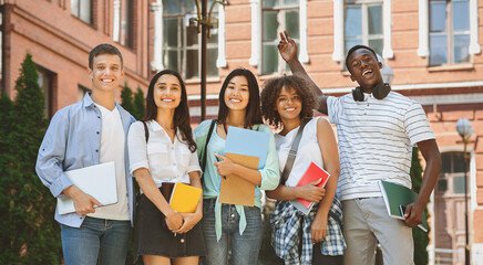 Freshmen Orientation Concept. Group Of First Year Students With Workbooks Posing Together Outdoors, Panorama With Free Space