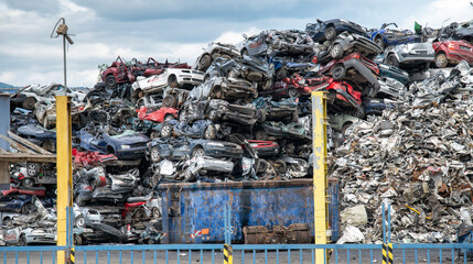 Pile of crushed cars in a junkyard. Car recycling.