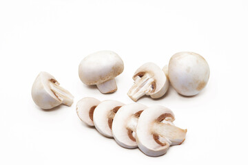 White button mushrooms sliced and whole on white