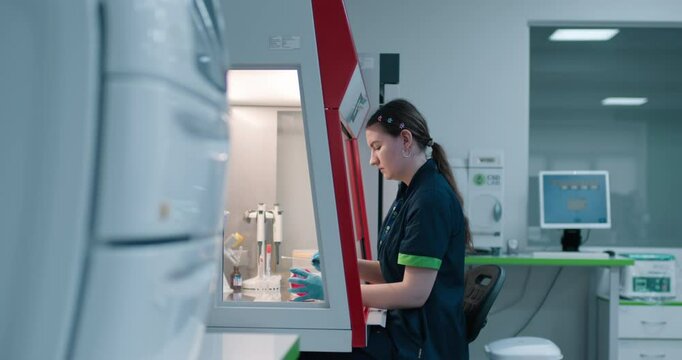 A biologist prepares biological material for diagnostics in a specialized lab box. Concept merging medicine and science in the study of biological samples for accurate diagnostics.