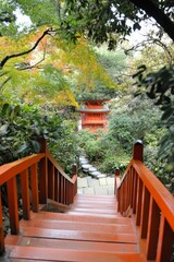 A pavilion and bridge are situated within a Japanese garden at Daigoji temple in Kyoto, Japan during the autumn season