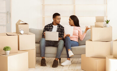 Upset black couple with laptop having problem with property documents, filing online complaint to...