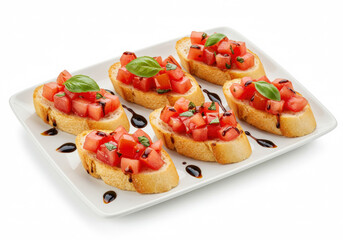 Fresh tomato bruschetta on toasted baguette slices with basil and balsamic glaze, arranged on a white rectangular plate isolated on white