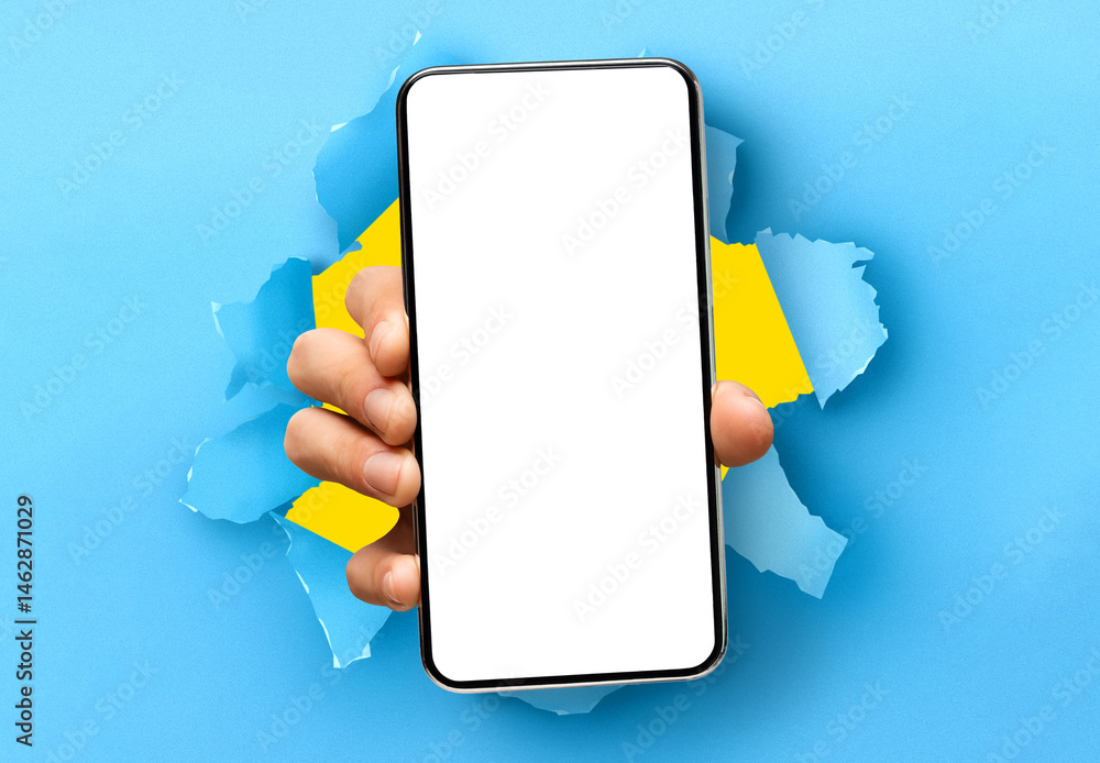 Poster Mobile App Promo, Great Offer. Closeup of hand holding smartphone with white empty screen showing device close to camera breaking through blue paper sheet. Blank display with free copy space, mock up