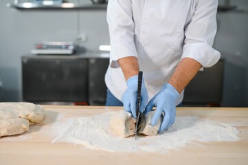 Baker man kneading dough and bakery ingredients. Bakery concept