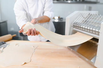 Man preparing pasta on kitchen table