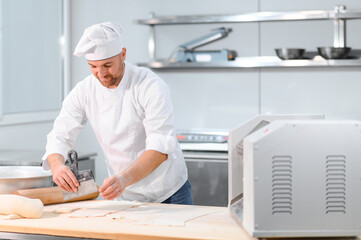 Man preparing pasta on kitchen table