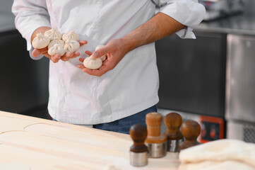 Production of semi-finished products. Sale of frozen food products. The cook makes khinkali or...