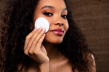 Portrait of a beautiful woman caring for her skin, showcasing natural beauty with a soft and...