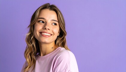 Fototapeta premium アーティスティックな構図で、くすみラベンダーの背景と視線を外した自然な笑顔を持つ20代白人女性の自由で軽やかな美しさ
