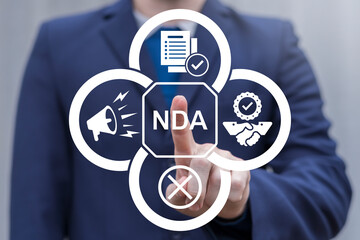 NDA or Non disclosure agreement contract concept. Person using virtual touch screen push abbreviation: NDA. Legal acknowledge signing of confidential NDA document.
