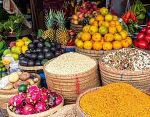 Vibrant market display bursting with fresh produce. Baskets overflow with colorful fruits, vegetables, and grains. Perfect for food, health, or travel themes.