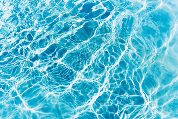 Ripples on the surface of the water in a blue swimming pool