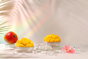 Modern minimal still life with exotic mango fruit on sunny table with palm tree shadows,summer holiday concept.Summer banner with tropical fruits,vegan food for weight loss