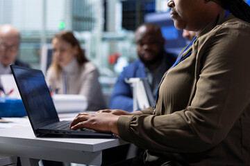 Factory management and shareholders work on manufacturing automation innovations using notebook, close up. Industrial plant managers and investors analyze production research data using laptop