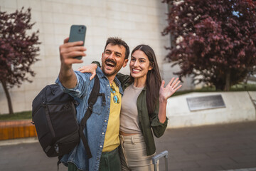 happy tourist couple take a self portrait while explore new city