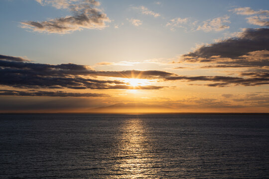A vibrant sunset casts its colors over Cook Inlet in Anchorage, Alaska.
