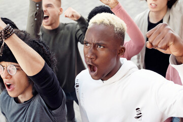 Multiethnic protestors striking against reforms on the street, closeup. International group of...