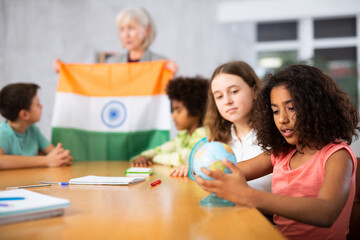 Fototapeta premium curious students listen attentively to the teacher who tells interesting facts about India