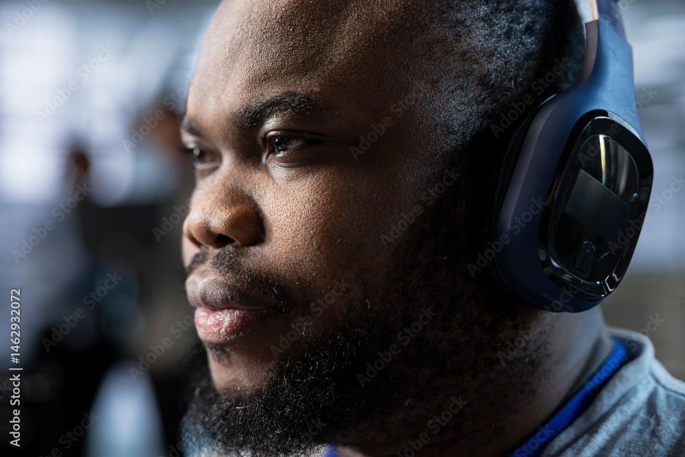 Poster admin in data center wearing headphones, coordinating deployment of server architecture, improving d