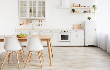 Home nordic interior. Idea of light scandinavian kitchen room interior with white and wooden dining furniture and floor, large light wall, empty space