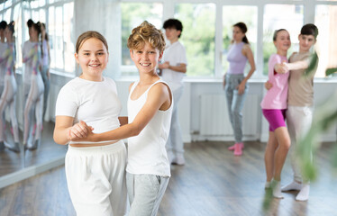 Pair of teen girl and guy enjoying of waltz dance in choreo class. Exciting hobby, active...