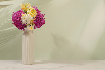 Beautiful banner of different varieties of hyacinths and muscari in a vase, template for design and screen. Abstract flower arrangement. Spring card, business card for product demonstration,