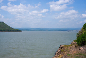 Landscape, water, sky, clouds and mountains above the dam.