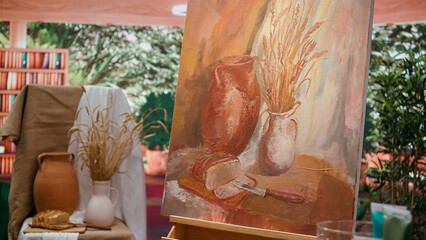 Modern paintwork supplies and coloring tubes or oil paints in creative atelier, brush kit and...